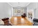 Open living area with a fireplace, hardwood floors, and large windows for natural light at 203 Shelby Ln, Fayetteville, GA 30215