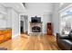 Bright living room with stone fireplace, hardwood floors, high ceilings, and ample seating at 203 Shelby Ln, Fayetteville, GA 30215