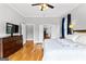 Spacious main bedroom features hardwood flooring, a ceiling fan and dresser at 203 Shelby Ln, Fayetteville, GA 30215