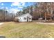 Charming white outbuilding featuring black shutters and a blue front door, surrounded by a black fence at 203 Shelby Ln, Fayetteville, GA 30215