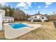 Gorgeous in-ground pool with diving board and lounge chairs with a scenic view of the home at 203 Shelby Ln, Fayetteville, GA 30215