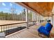 Relaxing covered porch with wood ceilings, comfortable seating, and scenic views of nature at 203 Shelby Ln, Fayetteville, GA 30215