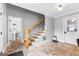 A staircase features wood handrails, stone tile flooring, and natural light from the back door at 203 Shelby Ln, Fayetteville, GA 30215