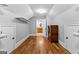 Walk-in closet with hardwood floors and doorway to a bathroom with a wood vanity at 203 Shelby Ln, Fayetteville, GA 30215