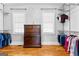 Walk-in closet featuring a dresser, shelving, and clothing racks with two windows at 203 Shelby Ln, Fayetteville, GA 30215