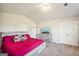 Bright bedroom with vaulted ceiling, carpeted floor, and double door closet at 316 Denton Way, Hampton, GA 30228