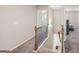 Second story hallway featuring carpet flooring and an open staircase with a wooden railing and metal spindles at 316 Denton Way, Hampton, GA 30228