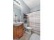 Bathroom featuring a wood vanity and a shower/tub combo with a curtain at 306 Interlake Pass, Mcdonough, GA 30252