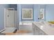 Bright bathroom featuring a glass enclosed shower, soaking tub, and vanity with dual windows at 306 Interlake Pass, Mcdonough, GA 30252