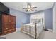 Bedroom with blue walls, hard wood furniture and ceiling fan at 306 Interlake Pass, Mcdonough, GA 30252