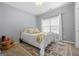 Bedroom with patterned rug, white comforter, and a window at 306 Interlake Pass, Mcdonough, GA 30252