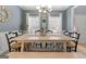 Dining room with a large wooden table, bench, and six chairs under a chandelier at 306 Interlake Pass, Mcdonough, GA 30252
