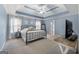 Spacious main bedroom with a trey ceiling, plush carpet, and natural light at 306 Interlake Pass, Mcdonough, GA 30252