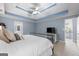 Main bedroom boasts a trey ceiling, carpet, and ensuite bathroom at 306 Interlake Pass, Mcdonough, GA 30252