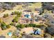 Expansive aerial view of a private residence featuring a pool, manicured lawn, and surrounding mature trees at 111 Dixson Rd, Bowdon, GA 30108