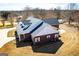 An aerial view showcases the brick home, the lush landscaping, and a winding driveway at 111 Dixson Rd, Bowdon, GA 30108