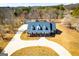 Aerial view of a stately brick home with prominent dormers and a circular driveway at 111 Dixson Rd, Bowdon, GA 30108