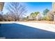 Expansive backyard with lush greenery, mature trees, and a large patio for entertaining at 111 Dixson Rd, Bowdon, GA 30108