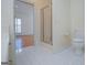 Bright bathroom with a glass-enclosed shower and doorway leading to a bedroom with wood floors at 111 Dixson Rd, Bowdon, GA 30108