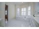 Bathroom featuring a soaking tub with tile surround and natural light at 111 Dixson Rd, Bowdon, GA 30108
