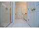 Clean bathroom featuring a glass-enclosed shower and a doorway leading to additional rooms at 111 Dixson Rd, Bowdon, GA 30108