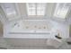 Bathroom featuring large tub with tile surround and a view from the window at 111 Dixson Rd, Bowdon, GA 30108