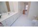 Bathroom showcasing a vanity with white cabinets and access to a bedroom with hardwood floors at 111 Dixson Rd, Bowdon, GA 30108