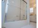 Bathroom tub and shower combination with sliding doors and tile flooring at 111 Dixson Rd, Bowdon, GA 30108