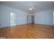 Bedroom features hardwood floors, white trim, and access to an ensuite bathroom and additional closet space at 111 Dixson Rd, Bowdon, GA 30108