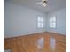 This spacious bedroom offers hardwood floors, white trim, and great natural lighting at 111 Dixson Rd, Bowdon, GA 30108