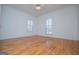 A spacious bedroom with hardwood floors and two windows for natural light at 111 Dixson Rd, Bowdon, GA 30108