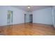 Bright bedroom showcasing hardwood floors, large windows, and a view into an ensuite bathroom at 111 Dixson Rd, Bowdon, GA 30108