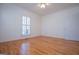 A comfortable bedroom with hardwood floors and a window for natural light at 111 Dixson Rd, Bowdon, GA 30108