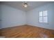 A bright bedroom features hardwood floors, a ceiling fan, and a window for natural light at 111 Dixson Rd, Bowdon, GA 30108