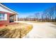 Long driveway leading to a house with a well-maintained lawn and mature trees at 111 Dixson Rd, Bowdon, GA 30108