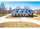 Stately brick home with a well-manicured lawn and a circular driveway offering curb appeal at 111 Dixson Rd, Bowdon, GA 30108