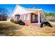 Brick home with a covered porch supported by white columns overlooking a landscaped yard at 111 Dixson Rd, Bowdon, GA 30108