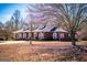 Inviting brick home with white trim, dormer windows, and covered porch offering a cozy and traditional style at 111 Dixson Rd, Bowdon, GA 30108