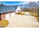 Beautiful brick home featuring a spacious three-car garage and a long concrete driveway at 111 Dixson Rd, Bowdon, GA 30108