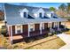 Charming brick home with a cozy front porch and classic white trim on a sunny day at 111 Dixson Rd, Bowdon, GA 30108