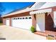 Attached two-car garage with white doors, adjacent to a welcoming entrance with a brick trim at 111 Dixson Rd, Bowdon, GA 30108