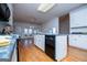 Bright kitchen featuring an island with black appliances and hardwood floors at 111 Dixson Rd, Bowdon, GA 30108