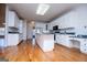 Bright kitchen featuring an island with black appliances and hardwood floors at 111 Dixson Rd, Bowdon, GA 30108