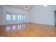 Bright living room with hardwood floors and large windows offering ample natural light at 111 Dixson Rd, Bowdon, GA 30108