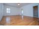 Spacious living room featuring hardwood floors, a ceiling fan, and natural light from a window at 111 Dixson Rd, Bowdon, GA 30108