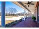 Covered brick porch with white columns, offering an outdoor seating area and landscaped garden views at 111 Dixson Rd, Bowdon, GA 30108