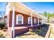 Covered brick porch adorned with white columns and manicured landscaping perfect for relaxing at 111 Dixson Rd, Bowdon, GA 30108