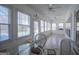 Light-filled sunroom with tile flooring, ceiling fans, and a view of the outdoors at 111 Dixson Rd, Bowdon, GA 30108