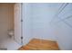 Walk-in closet with ample shelving and doorway view of an attached bathroom at 111 Dixson Rd, Bowdon, GA 30108