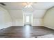 The bonus room features wood flooring, neutral paint, and natural light at 12 Paces Lakes Overlook, Dallas, GA 30157